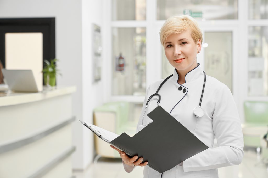 female doctor coat holding folder